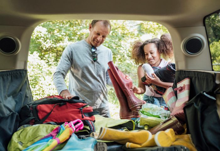 Father and daughter packing car for a holiday in Woolacombe